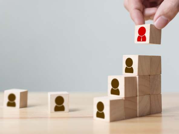 wooden blocks being stacked featuring outlines of people